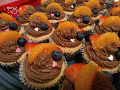 Gluten-free cupcakes with chocolate cream and fruit