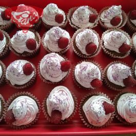 Gluten-free and dairy-free cupcake with cherry and raspberry whipped cream
